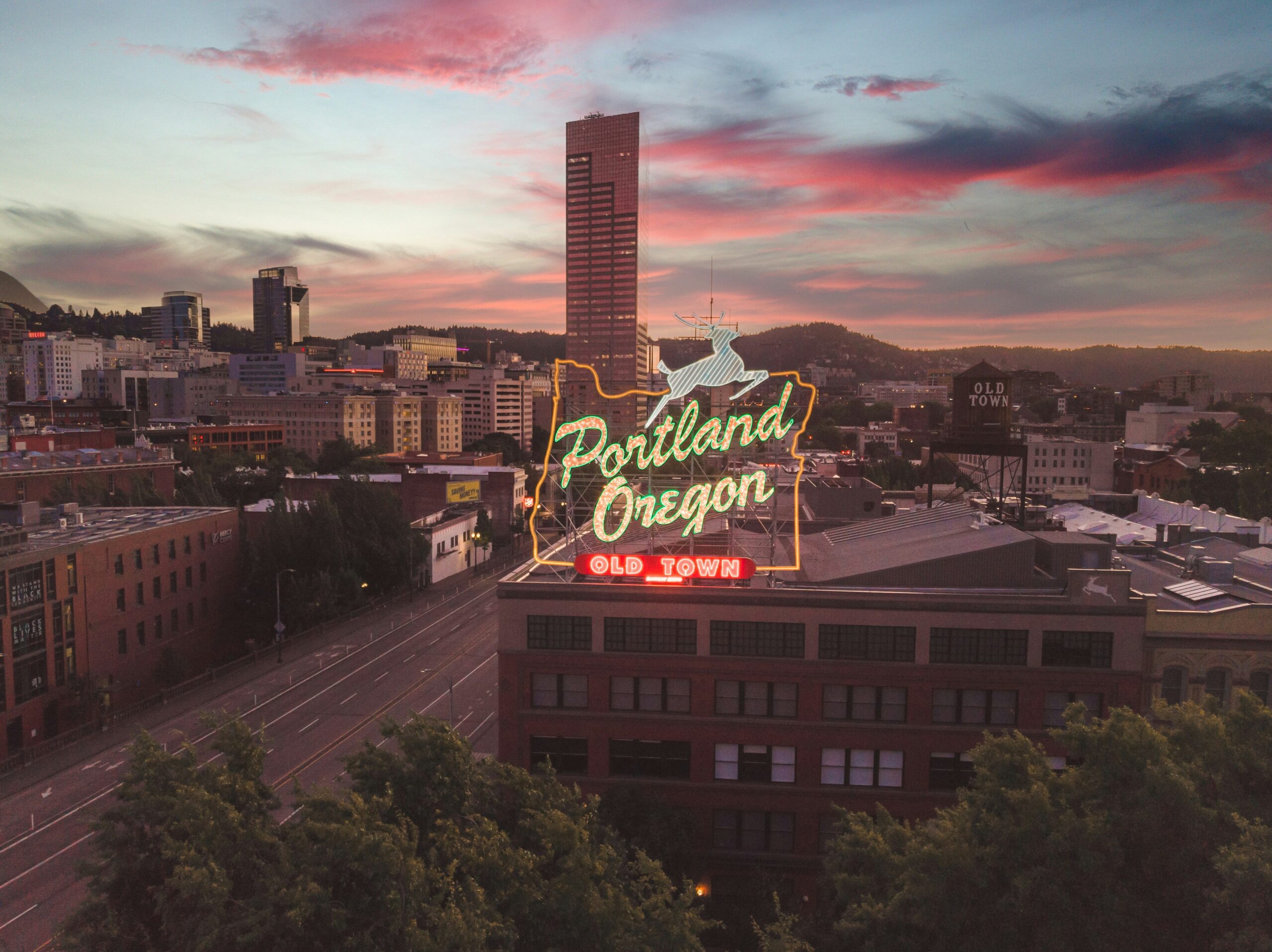 Portland Oregon sign and downtown skyline at sunset